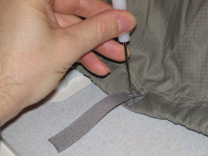 Use the awl to pierce the fabric.